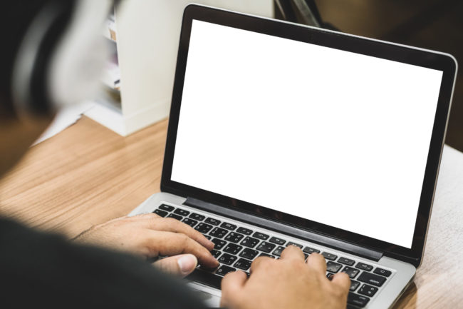 Back side of Asian business man wearing headphone and using lapt